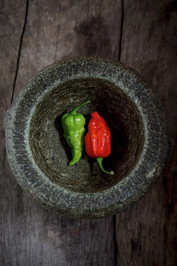 Two Fresh Chillis In A Mortar Photograph by Nitin Kapoor
