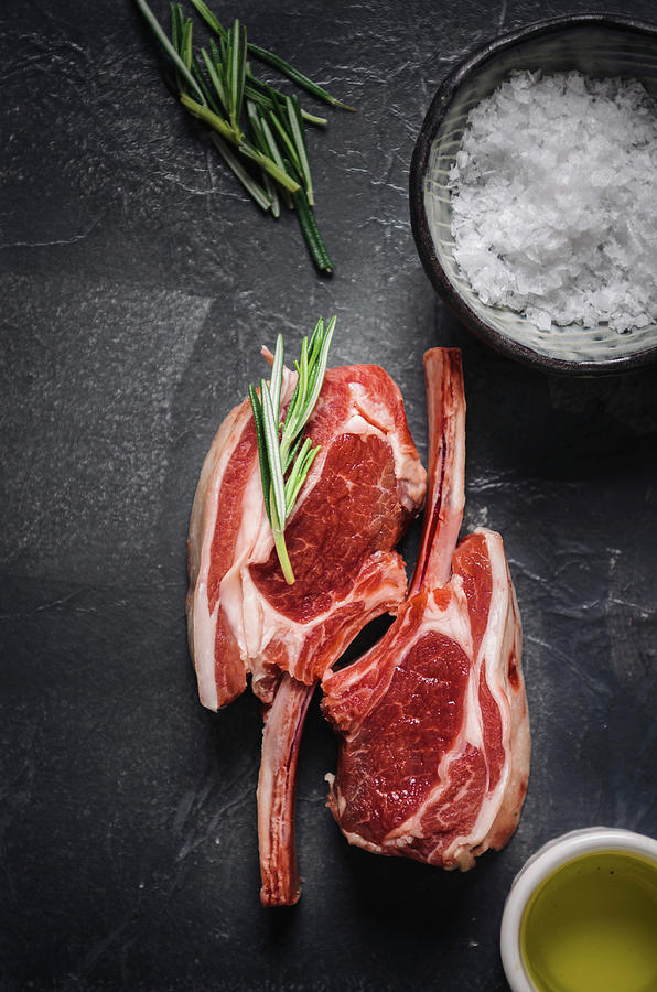 Two Fresh Lamb Chops, Sea Salt Flakes, Olive Oil And Rosemary Photograph by Nick Sida