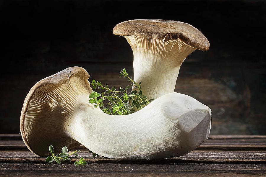 Two Fresh Mushrooms And Thyme Photograph by Christian Schuster