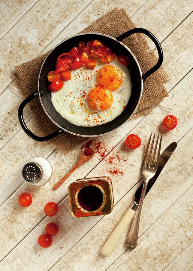 Two Fried Eggs And Fried, Chopped Tomatoes Sprinkled With Paprika In A Pan Photograph by Jane Saunders