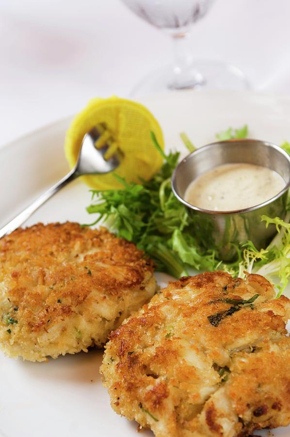 Two Giant Crab Cakes With Dipping Sauce Photograph by Rank, Erik
