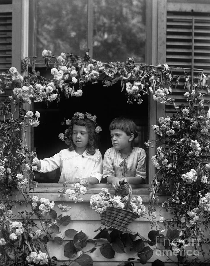 Two Girls 8-9 Standing In Window Photograph by Bettmann