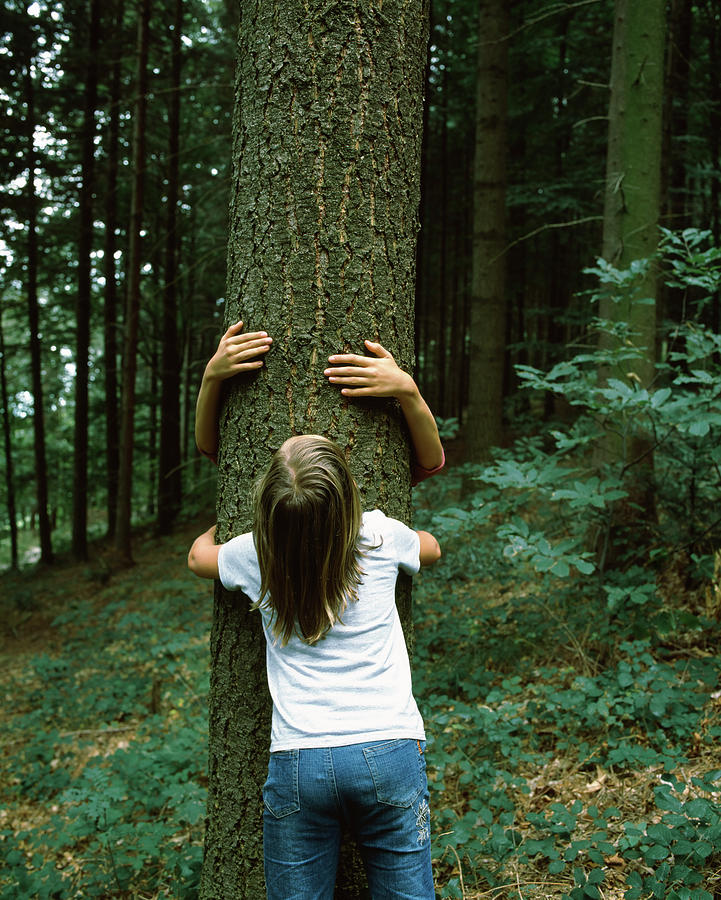Two Girls Hugging A Tree, Germany Photograph by Panoramic Images