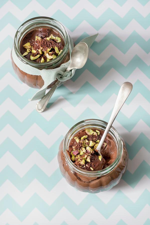 Two Glasses Of Chocolate Pudding With Pistachios And Spoons Photograph by Edyta Girgiel