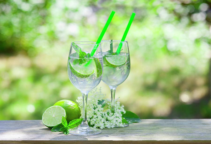 Two Glasses Of Hugo With Limes, Mint And Elderflower Syrup Photograph by Foodografix