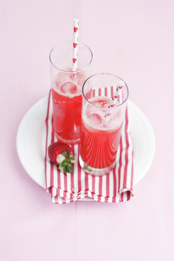 Two Glasses Of Raspberry Lemonade With Straws Photograph by Claudia Gargioni