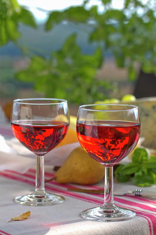 Two Glasses Of Ros Wine On Table Outdoors Photograph by Angela Francisca Endress