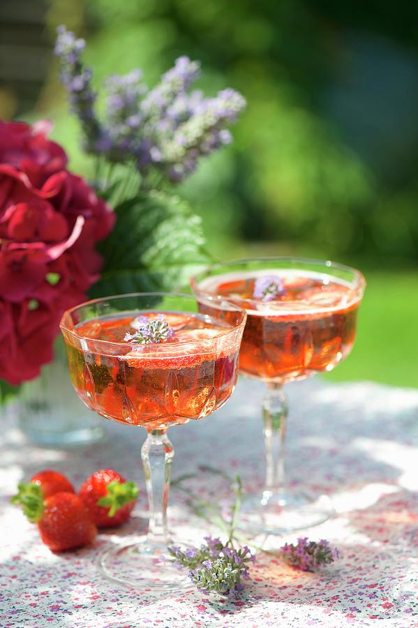 Two Glasses Of Strawberry Prosecco With Lavender Flowers Photograph by Winfried Heinze