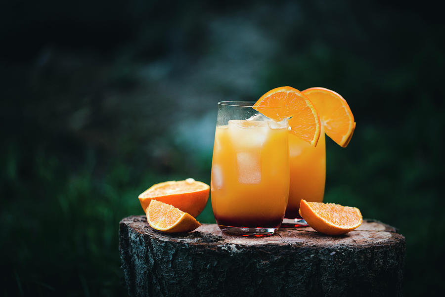 Two Glasses Of Vodka Sunrise Made With Orange Juice And Grenadine Photograph by Kati Neudert