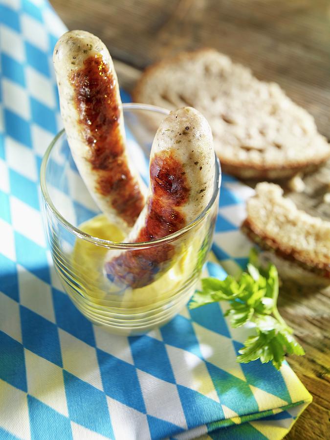 Two Grilled Bratwurst Sausages In A Glass With Mustard Photograph by Studio R. Schmitz
