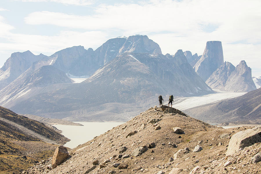 Mountain Photograph - Two Hikers Stand On High Mountain Ridge In Akshayak Pass Baffin Island by Cavan Images