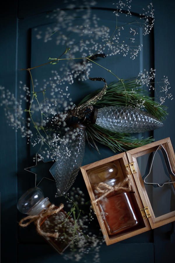 Two Jars Of Honey, Gypsophila And Glass Pine Cones On Blue Surface Photograph by Alicja Koll