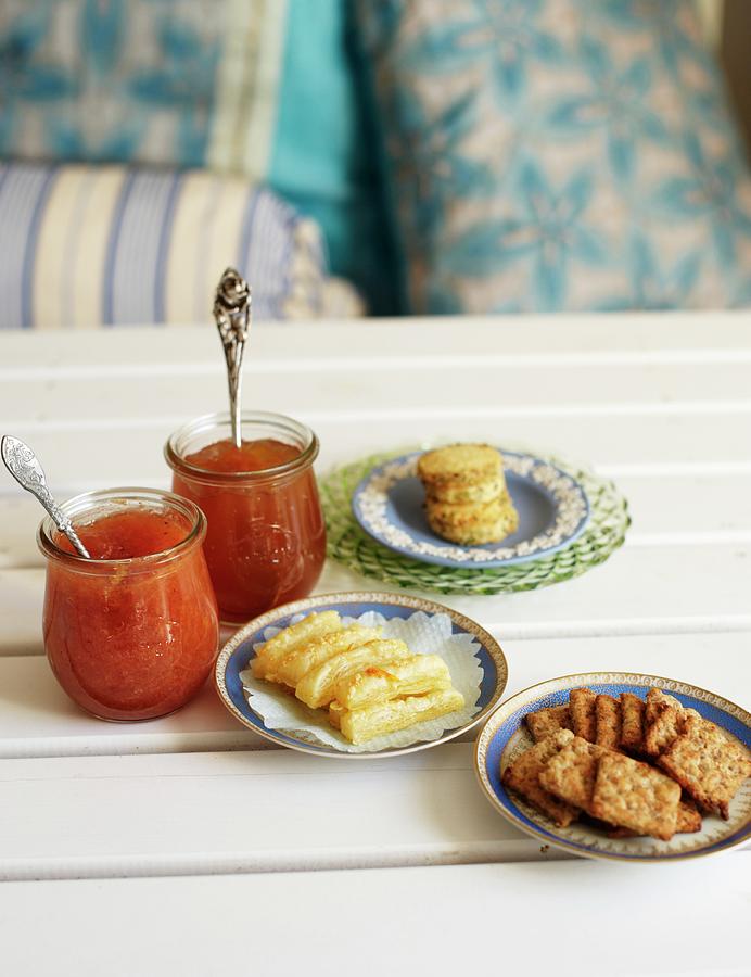 Two Jars Of Jam, Rosemary And Parmesan Crackers And Nut Crispbread Photograph by Hannah Kompanik