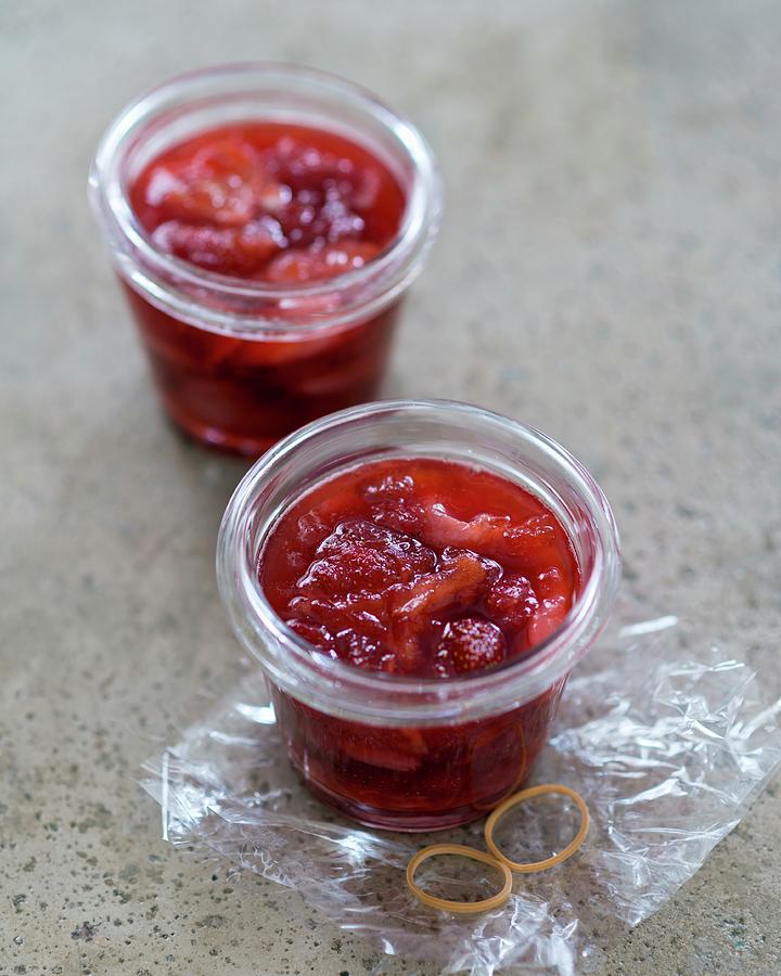 Two Jars Of Lychee And Strawberry Jam Photograph by Anthony Lanneretonne