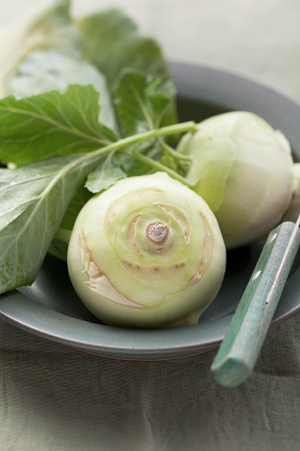 Two Kohlrabi In A Bowl With A Knife Photograph by Foodcollection