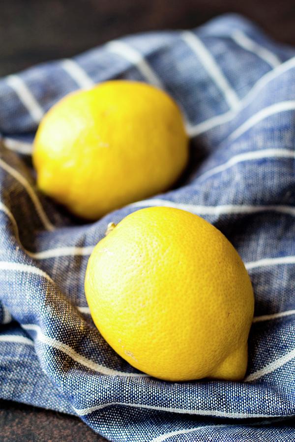 Two Lemons On A Blue And White Striped Linen Cloth Photograph by Christine Siracusa
