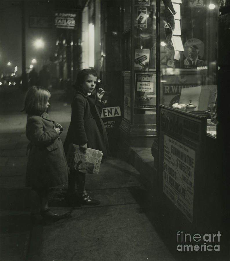 Two Little Girls In Winter Coats Standing Outside A Shop At Night ...