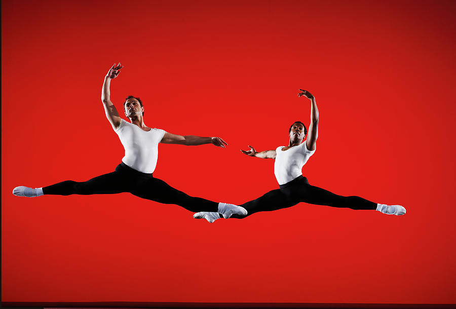 Two Male Ballet Dancers Leaping On Stage Photograph by Thomas Barwick