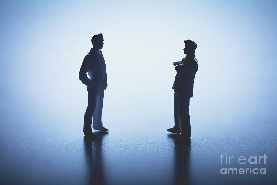 Two man standing face to face on white background. Photograph by Michal Bednarek