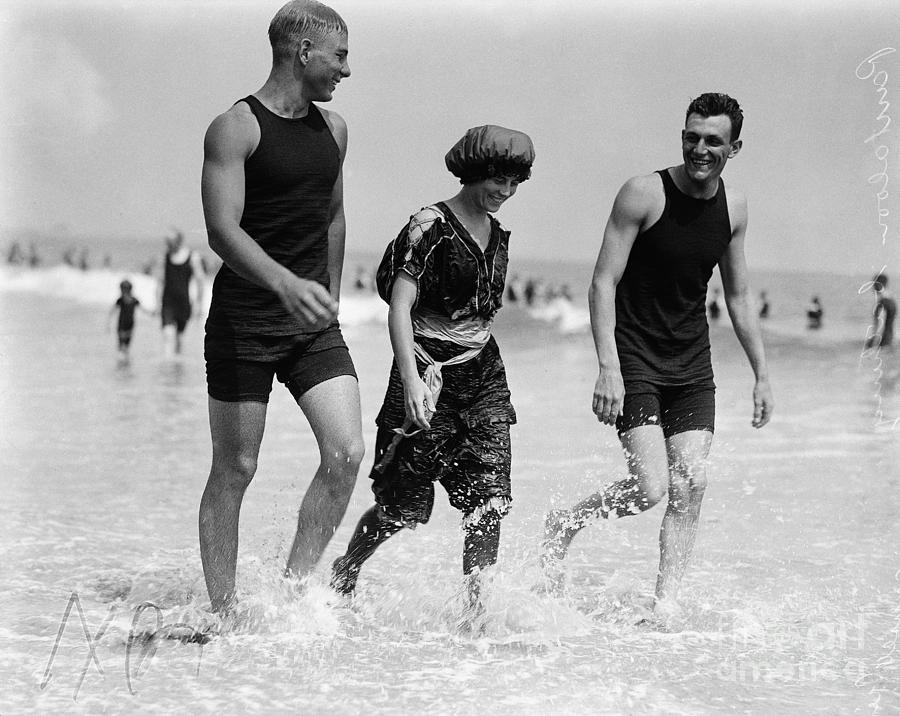 Two Men And A Woman At Beach Photograph by Bettmann