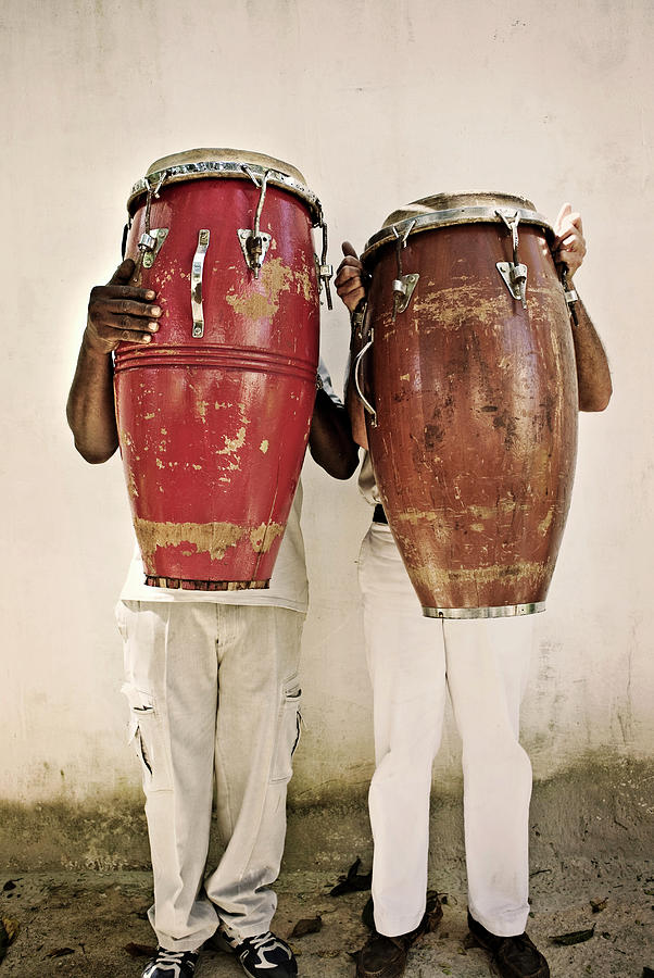 Two Men Holding Bongos In Front Of Photograph by Holly Wilmeth