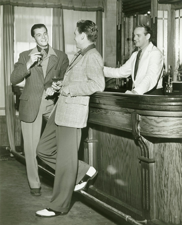 Two Men Talking At Bar Counter By George Marks