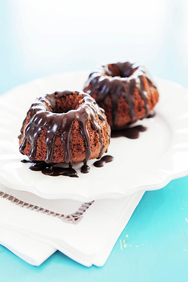 Two Mini Bundt Cakes With Chocolate Glaze Photograph by Anneliese Kompatscher