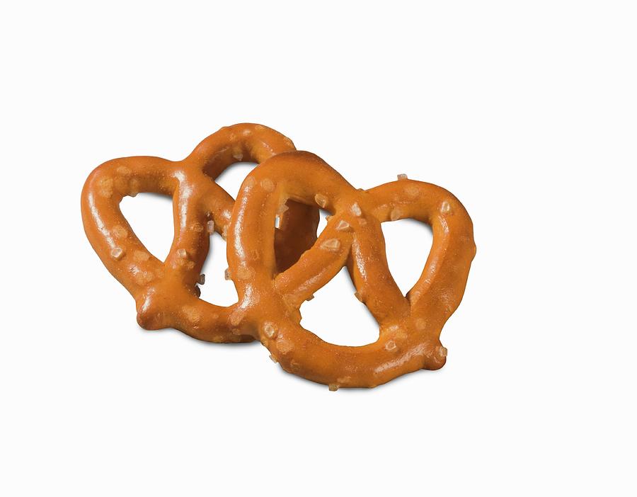 Two Mini Salted Pretzels On A White Surface close-up Photograph by Colin Cooke