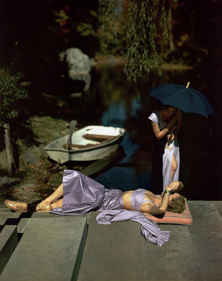 Two Models At The Edge Of A Pond Photograph by John Rawlings