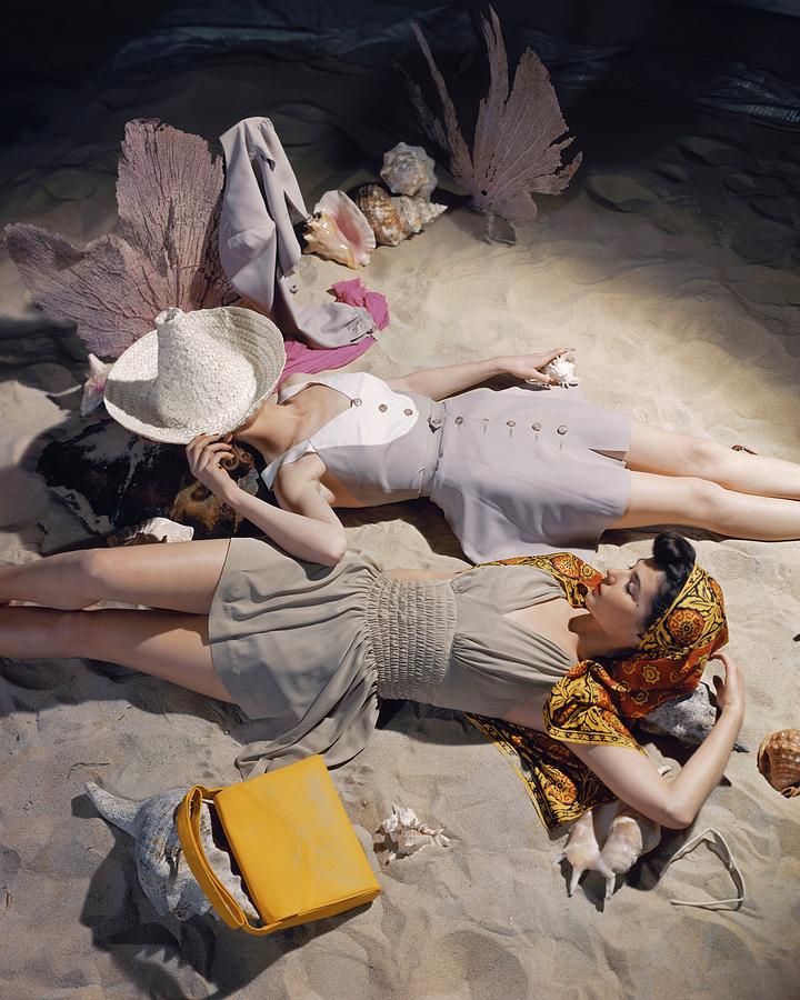Two Models Laying In The Sand Photograph by John Rawlings