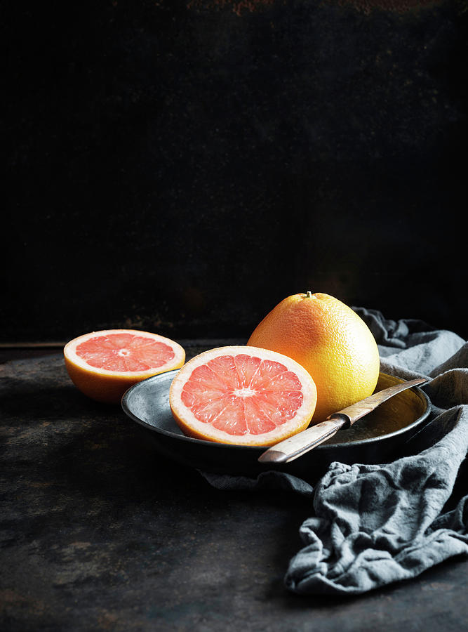 Two Pink Grapefruit citrus Paradisi On A Metal Plate Photograph by Kati Neudert