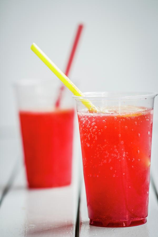 Two Plastic Cups Raspberry Syrup Photograph by Vulman Pter
