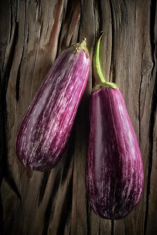 Two Purple Striped Aubergines On A Wooden Background Photograph by Shawn Driman Photography