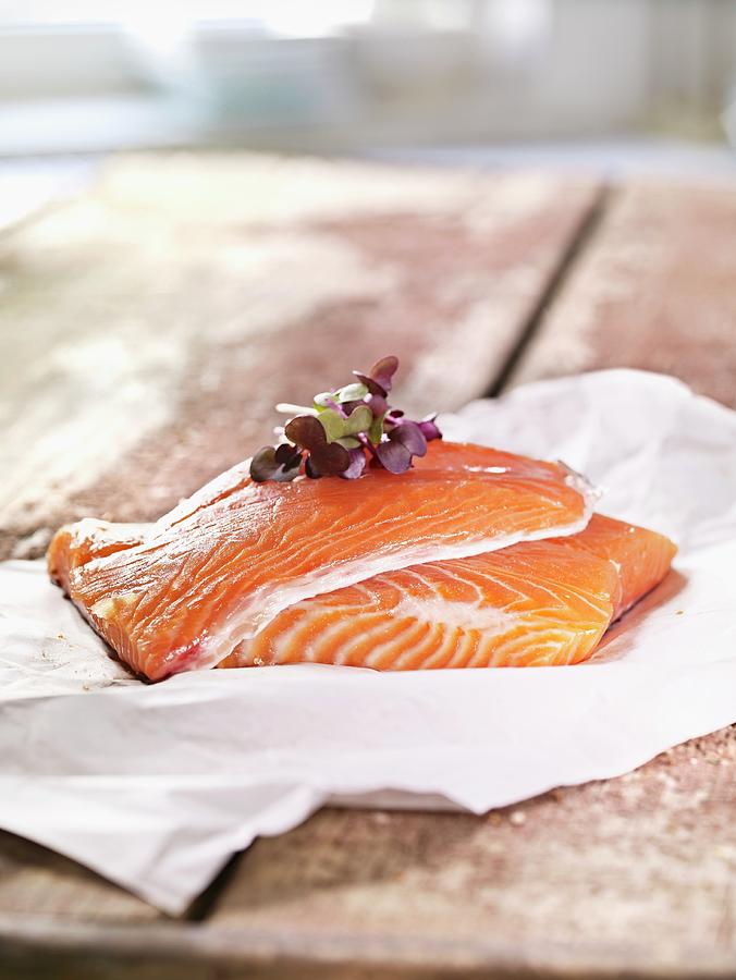 Two Raw Salmon Steaks On Parchment Paper Photograph by Till Melchior