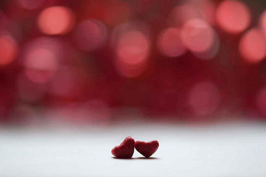 Two Red Hearts And Red Bokeh Background Photograph by G.g.bruno