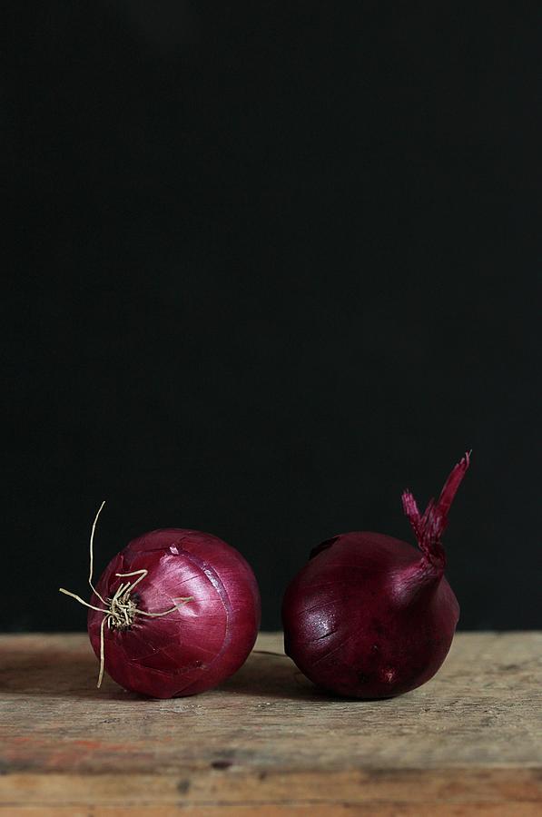 Two Red Onions Against A Dark Background Photograph by Vivi Dangelo
