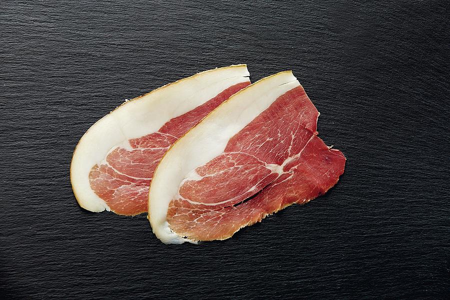 Two Slices Of Ham On The Bone From Acorn-fed Pigs Photograph by Jalag / Michael Bernhardi