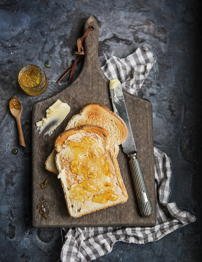 Two Slices Of White Bread Toasted And Covered With Butter And Marmalade Photograph by Stacy Grant