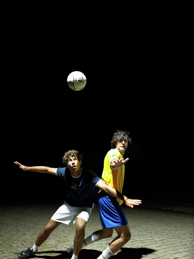 Two Soccer Players Heading Ball, Night Photograph by Hans Neleman