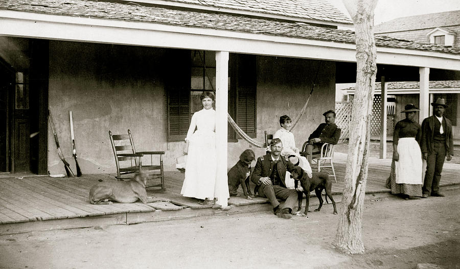 Two soldiers and two women on porch, with Afro-American woman and man ...