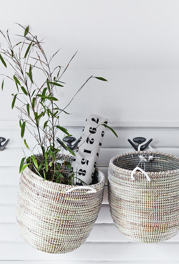 Two Storage Baskets Hung From Coat Hooks Photograph by Nicoline Olsen
