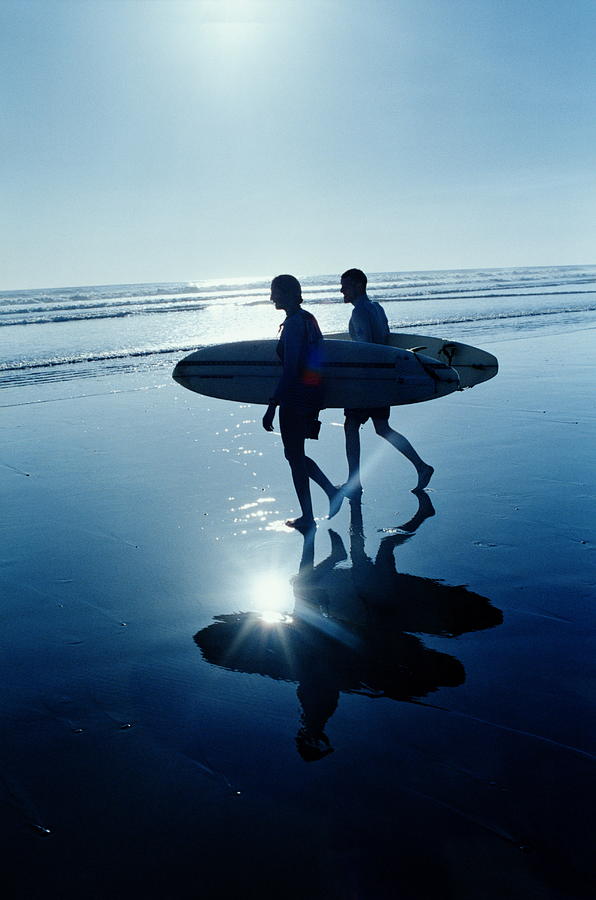 Two Surfers Holding Surfboards, Walking Photograph by Matthias Clamer