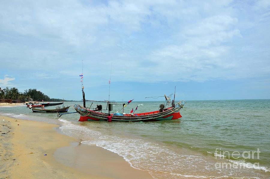 Two Thai fishermen take equipment onto boat at seaside Pattani Thailand Photograph by Imran Ahmed
