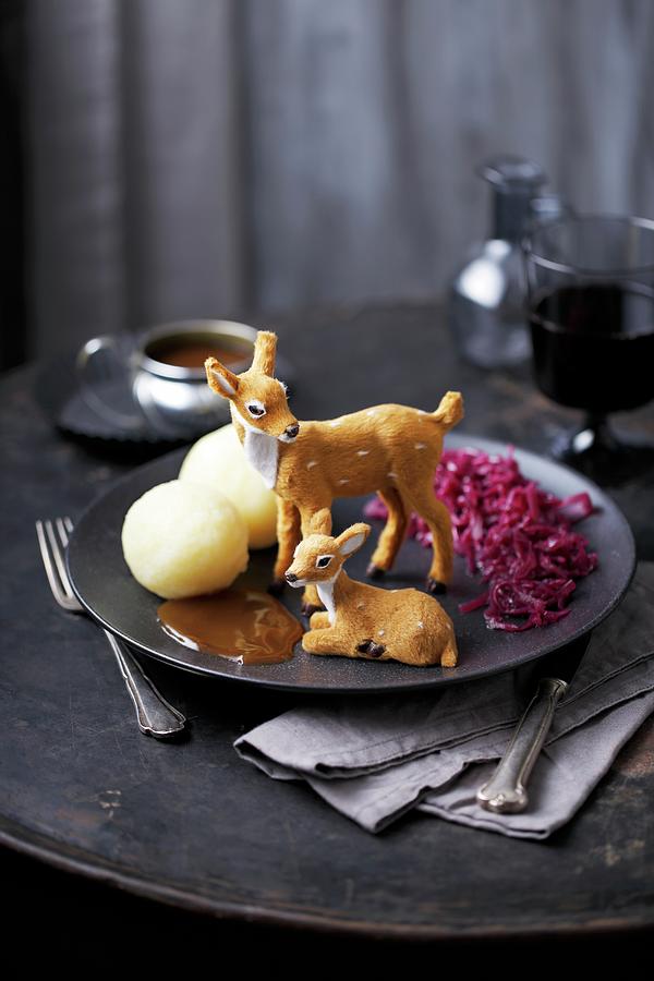 Two Toy Deer On A Plate With Red Cabbage, Dumplings And Gravy Photograph by Mona Binner Photographie