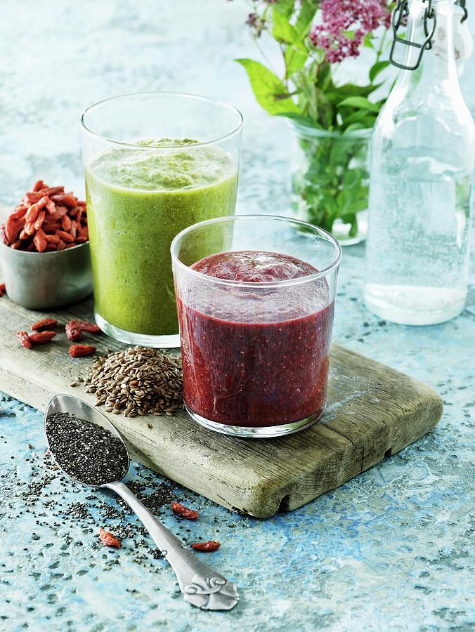 Two Vegetable Smoothies And Ingredients On A Wooden Board Photograph by Mikkel Adsbl