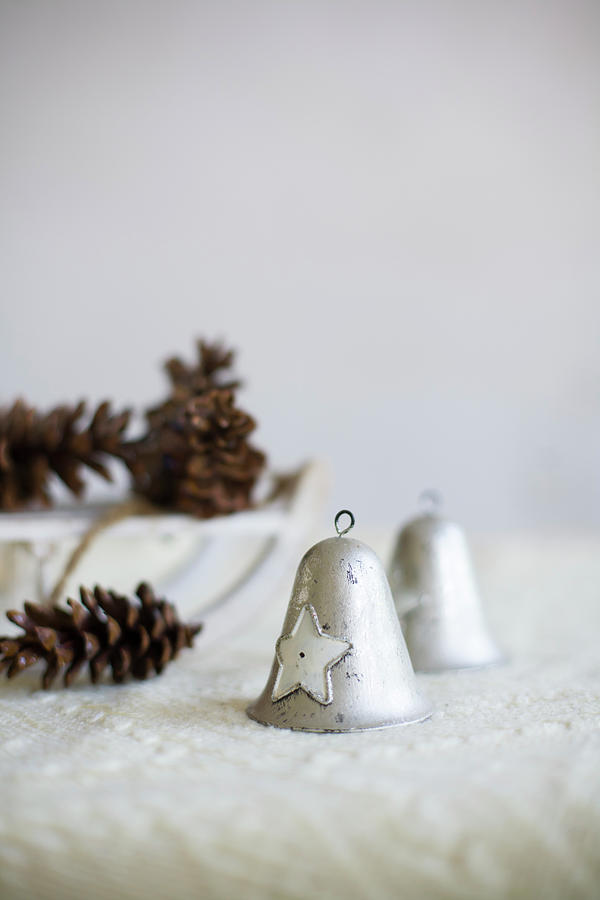 Two Vintage-style Bells And Pine Cones On White Blanket Photograph by Alicja Koll