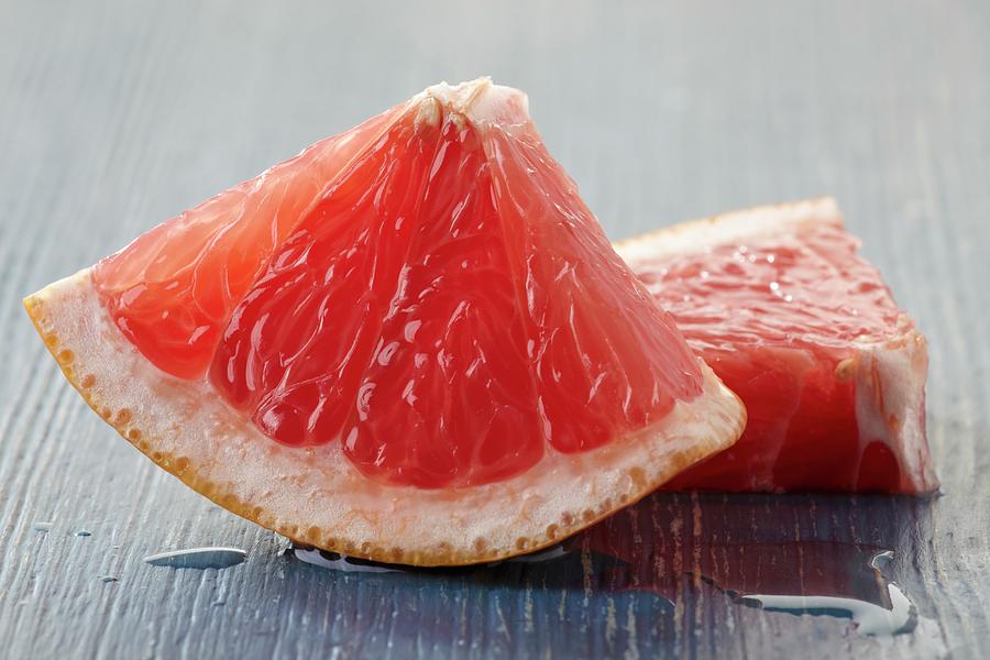 Two Wedges Of Pink Grapefruit Photograph by Zemgalietis, Maris