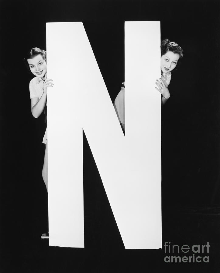 Big Photograph - Two Women Hiding Behind Huge Letter N by Everett Collection Big Photograph - Two Women Hiding Behind Huge Letter N by Everett Collection