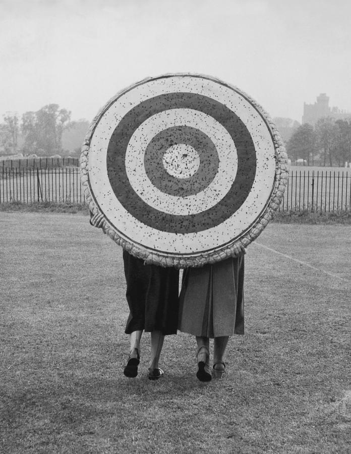 Two Women Holding Up Archery Target In Photograph by Fpg