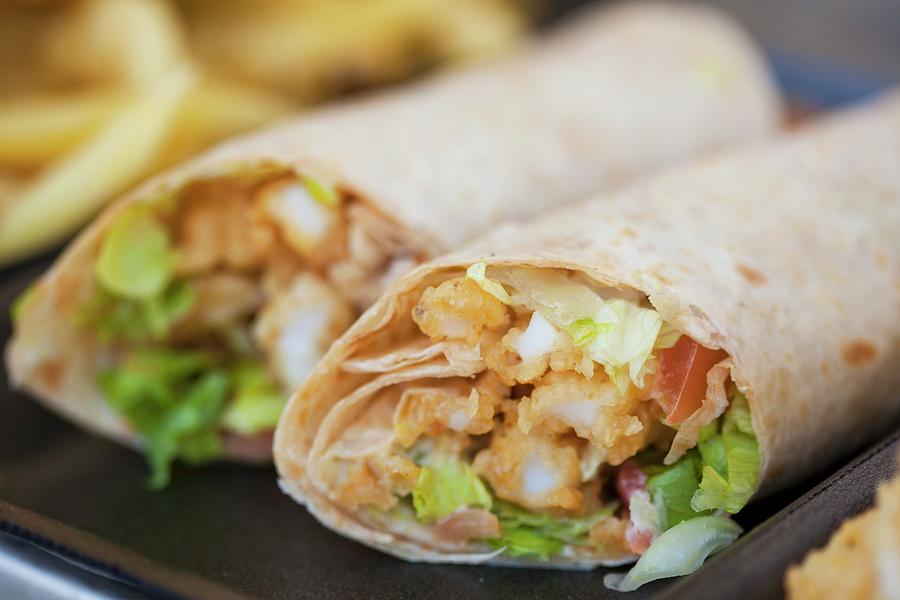 Two Wraps With Fried Calamari And Lettuce Photograph by Creative Photo Services
